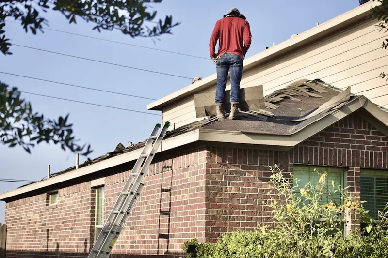 Professional roofer working on a residential roof in Waterfront South
